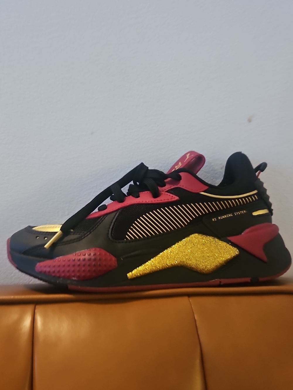 Puma Black and Gold Athletic Sneakers with Pink Accents